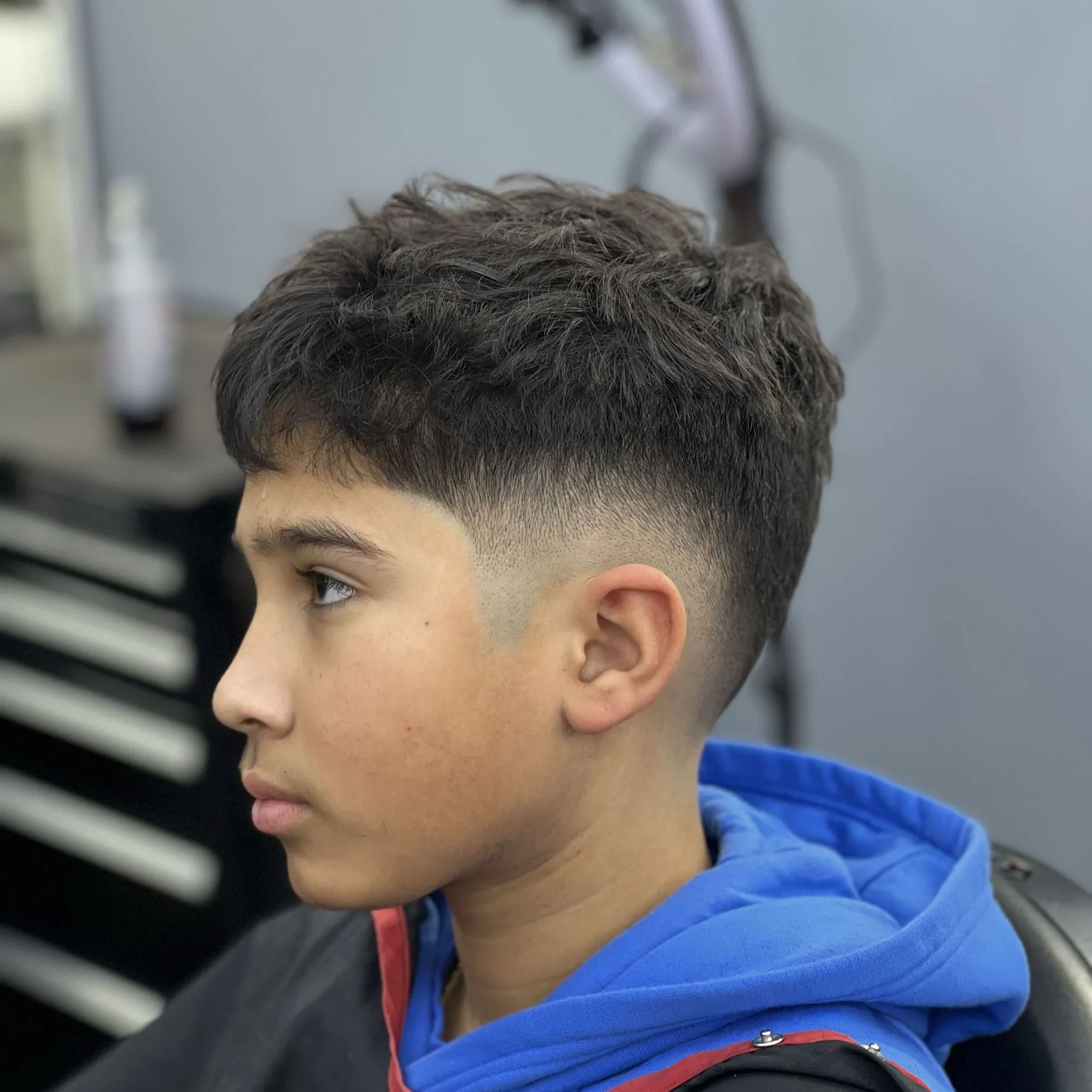 Kids mid fade with textured top, cut at DomiBarberz in Penndel