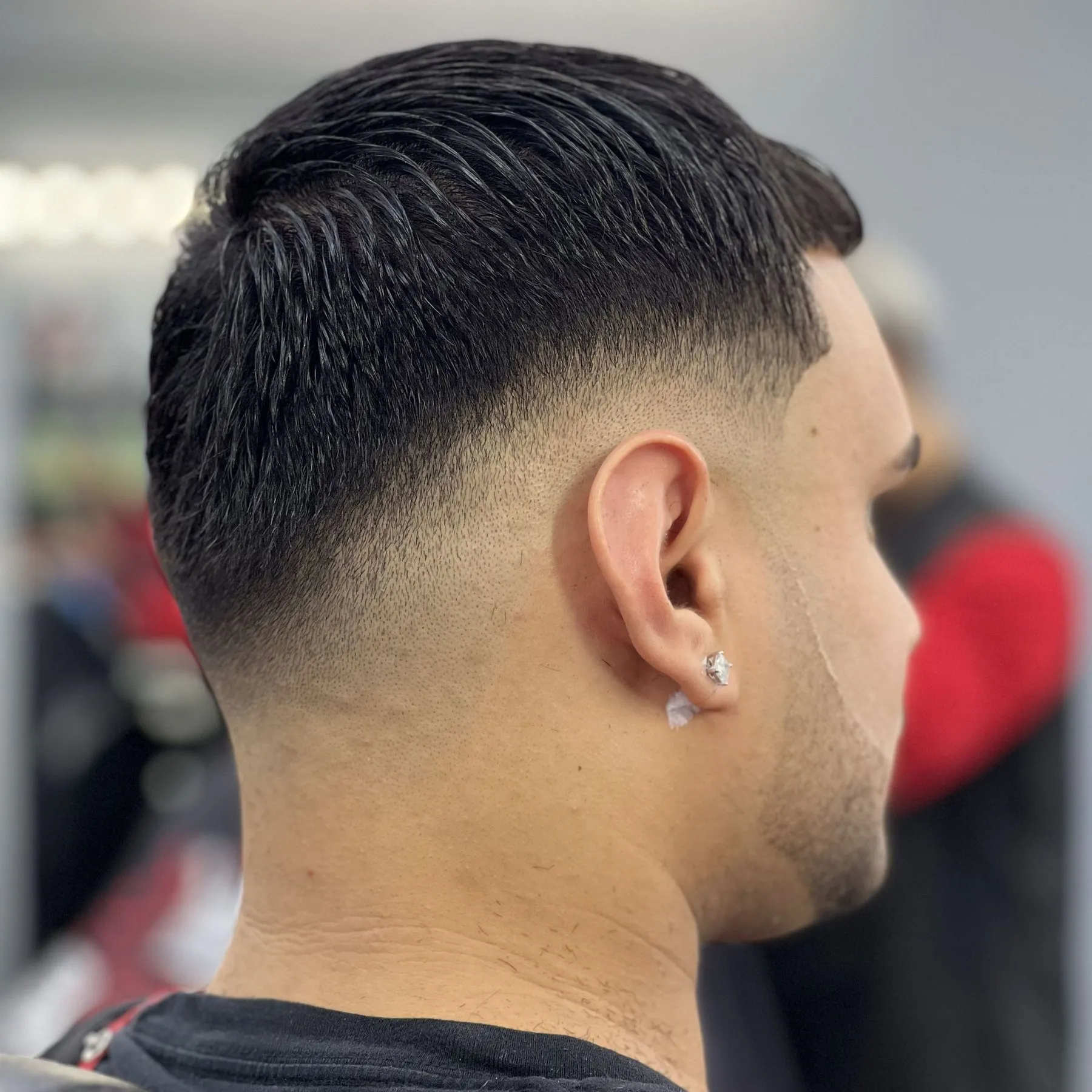 Slicked-back style with a low taper